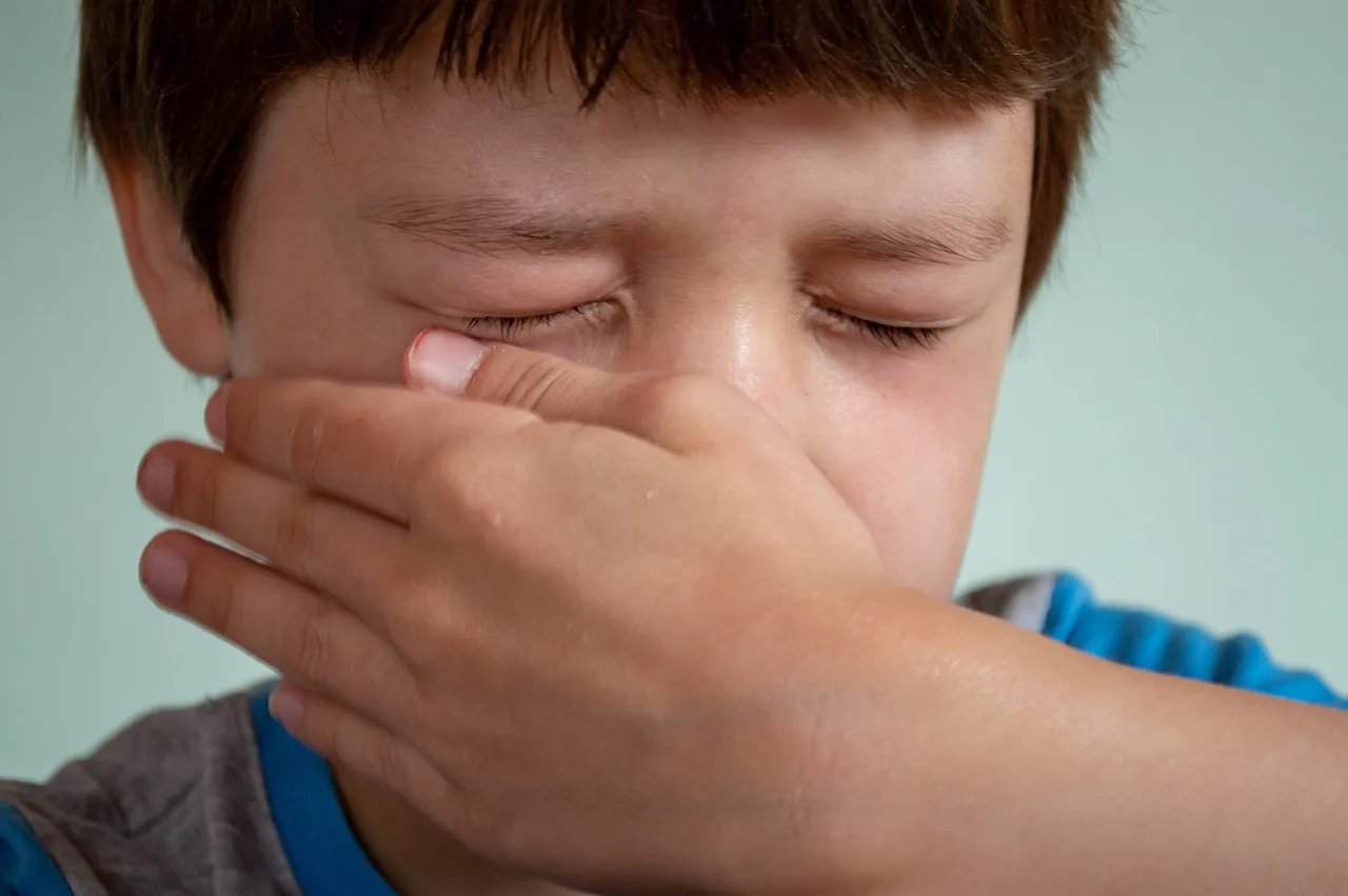A young boy crying and covering his face — the emotional toll of religious trauma on children