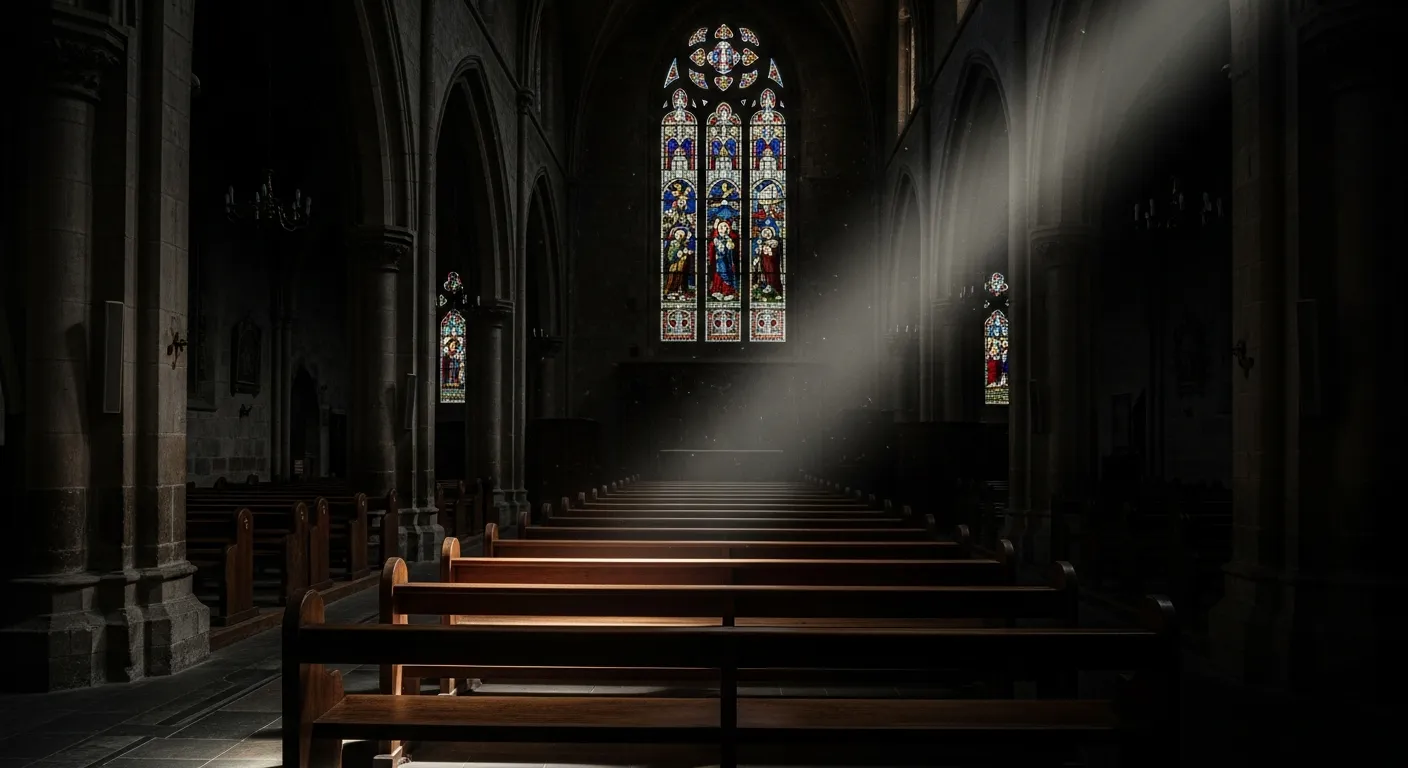 An empty church pew in a dark interior with a single beam of light — the spiritual emptiness of high-control churches